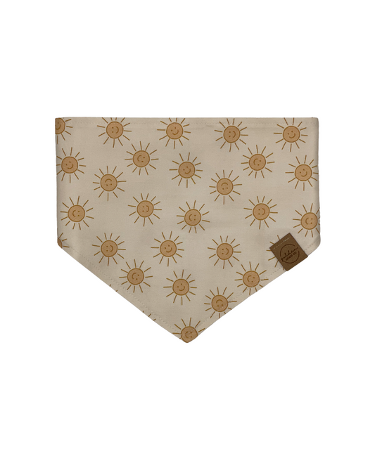 cream colored pet bandana patterned with smiling yellow suns